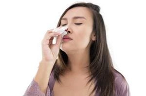 Woman Experiencing Nosebleeds Caused by Turbinate Hypertrophy