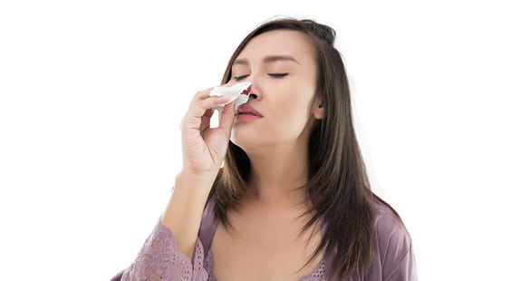 Woman-Experiencing-Nosebleeds-Caused-by-Turbinate-Hypertrophy